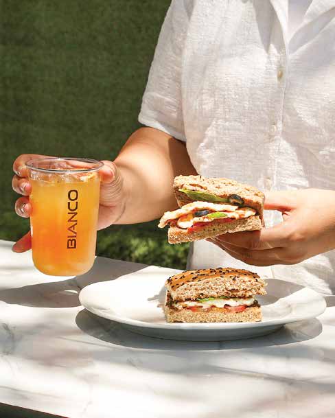 A Bianco house sandwich and a chilled fruit juice in a branded cup
