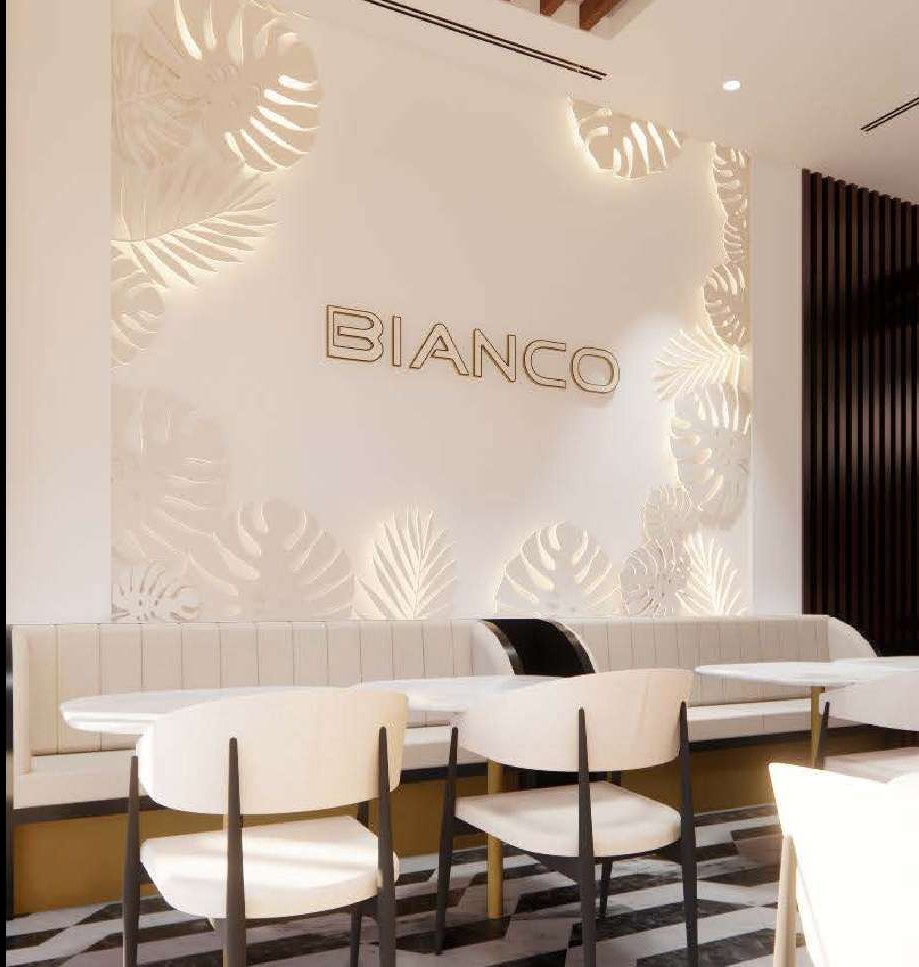 Bianco signage on a leaf-relief wall above cream banquette seating
